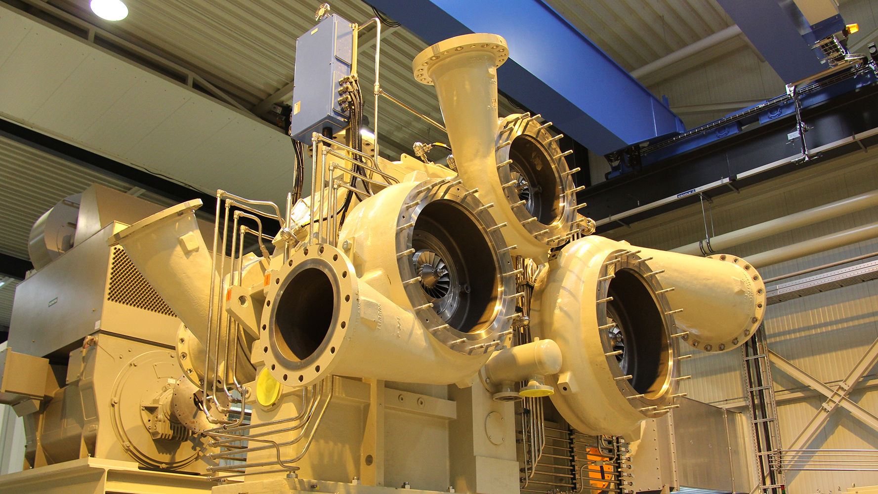 A white 6-stage integrally geared centrifugal compressor is shown on the test field at BZM without process gas piping.