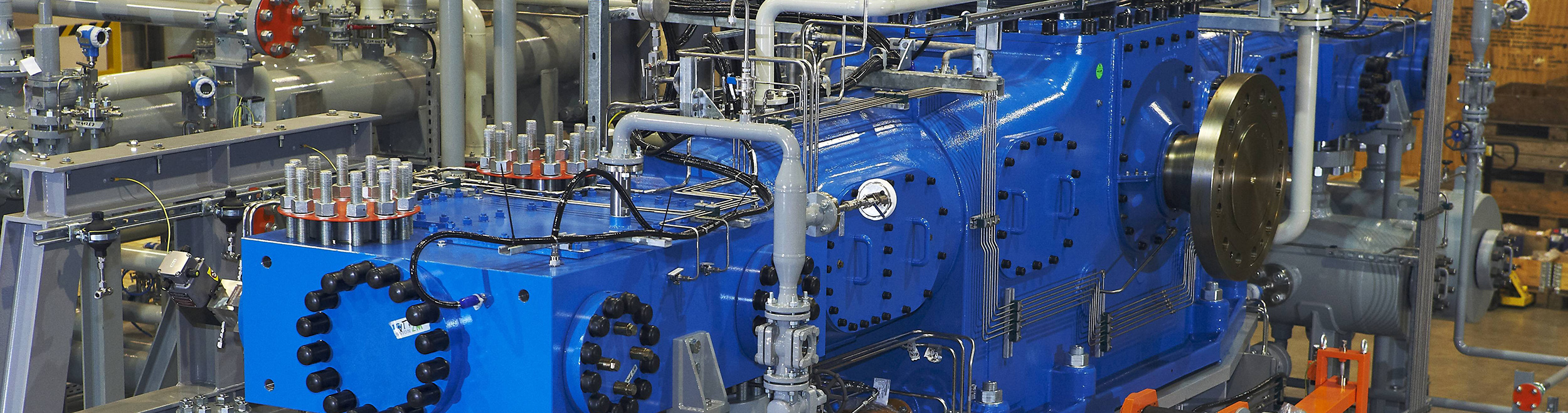 Shown is a section of a blue reciprocating compressor in boxer design.